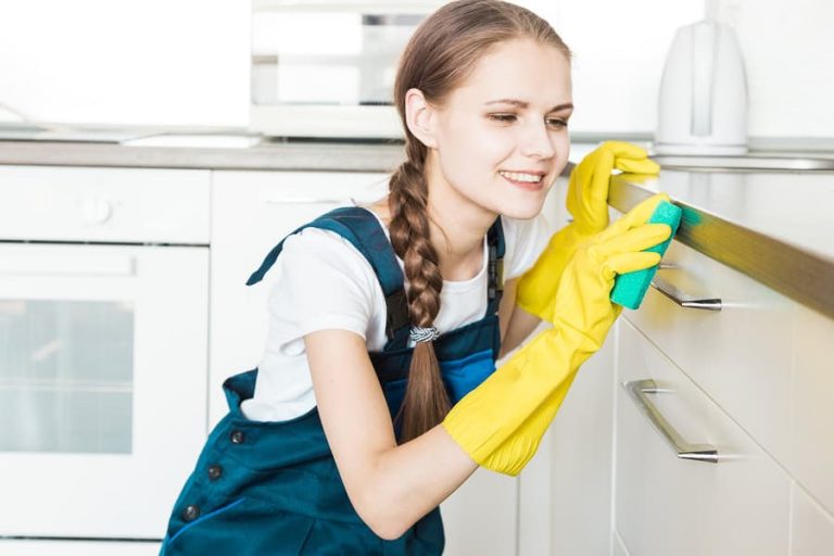a picture of a girl cleaning a kitchen